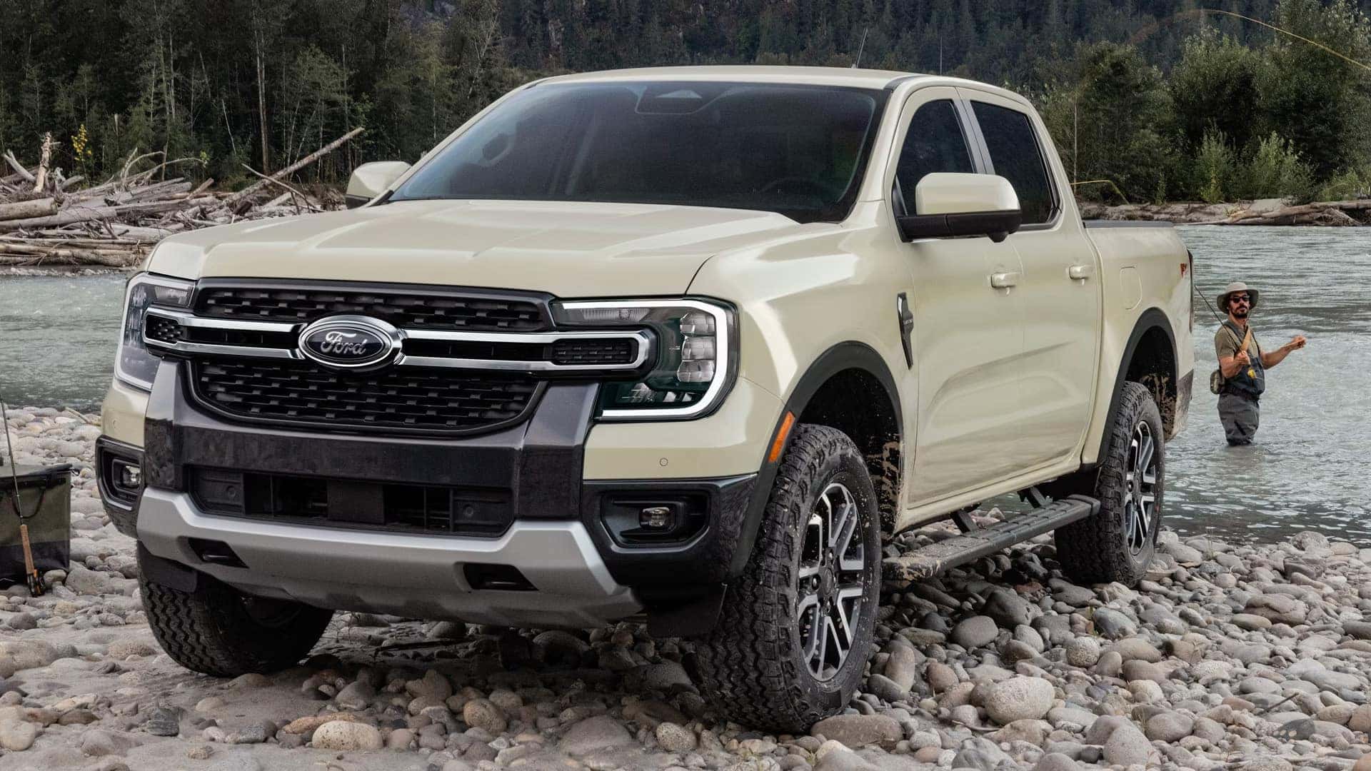White 2026 Ford Ranger 4x4 parked on a rocky riverbank near a forest