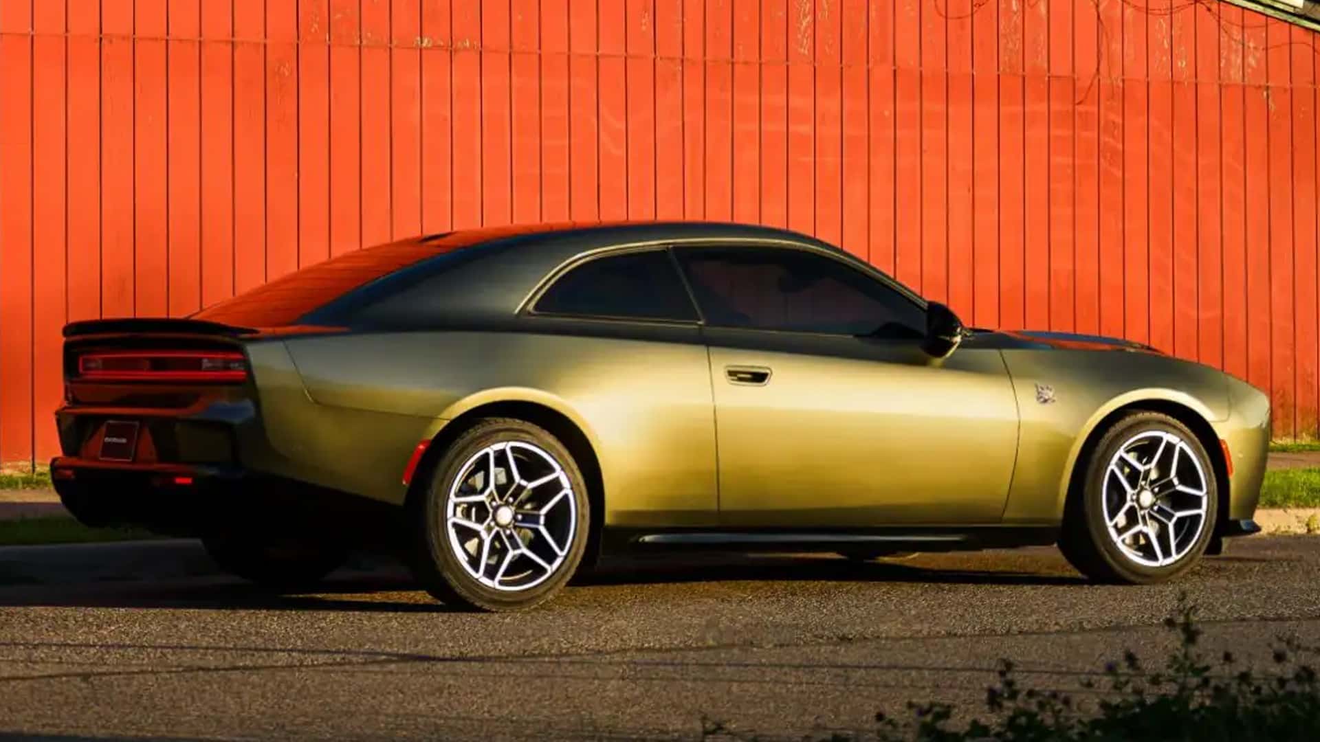 Green two-door Dodge Charger shown in side profile with a black roof, rear spoiler, and silver wheels.