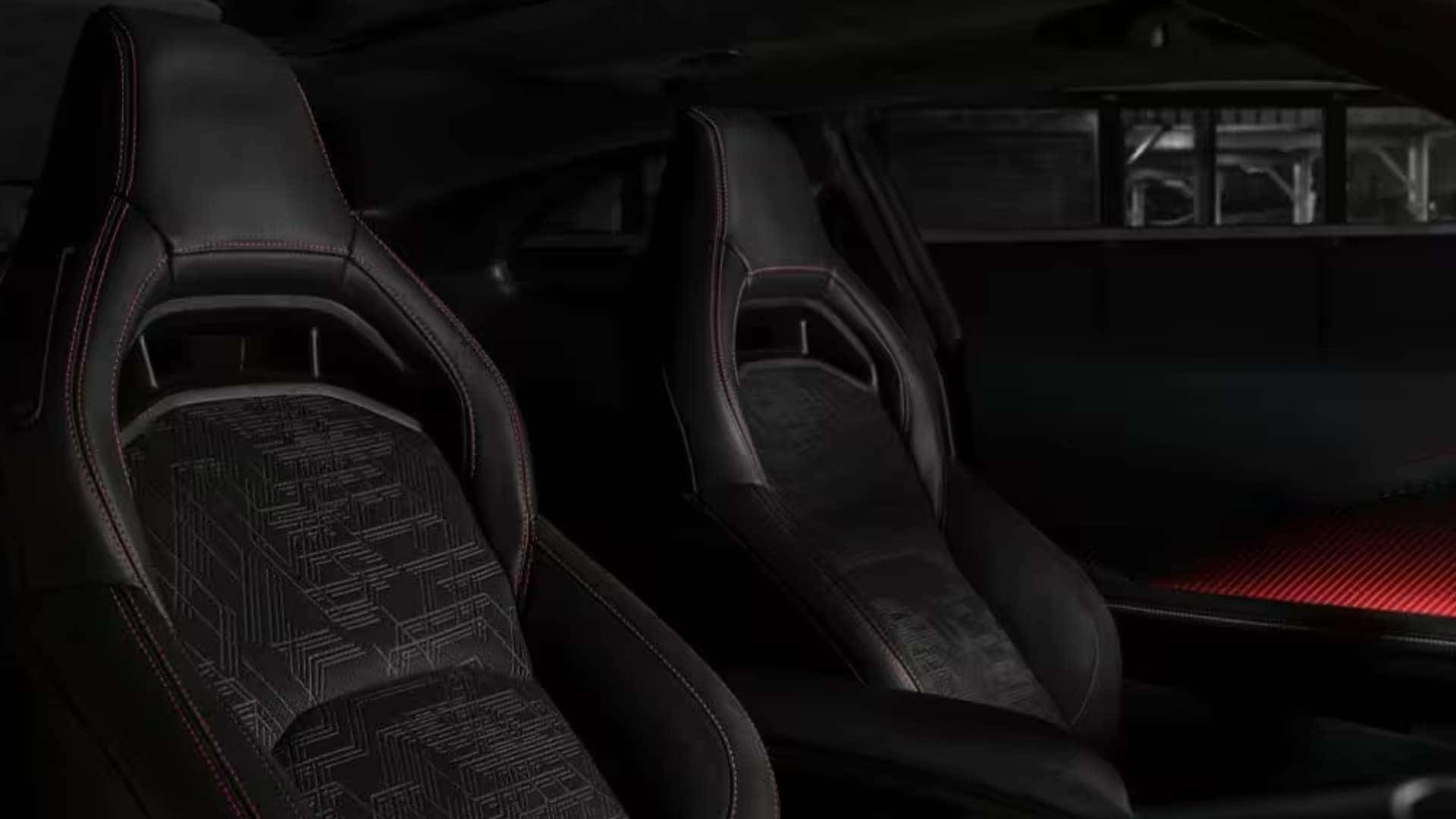 Two black front sport seats with patterned center inserts, red stitching, and red ambient lighting on the door.