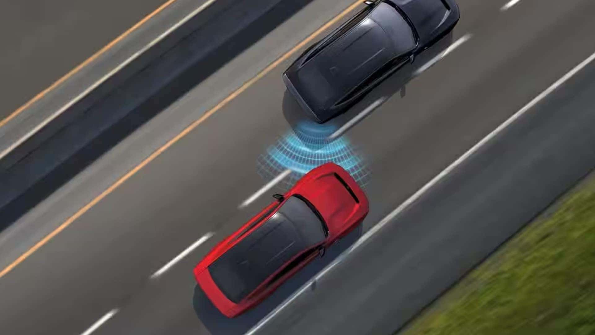 Overhead view of a red car following a dark car on a multilane road with blue sensor graphics between them.