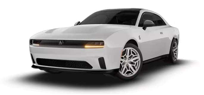 White two-door Dodge Charger shown from a front three-quarter angle with silver wheels and amber front lights.