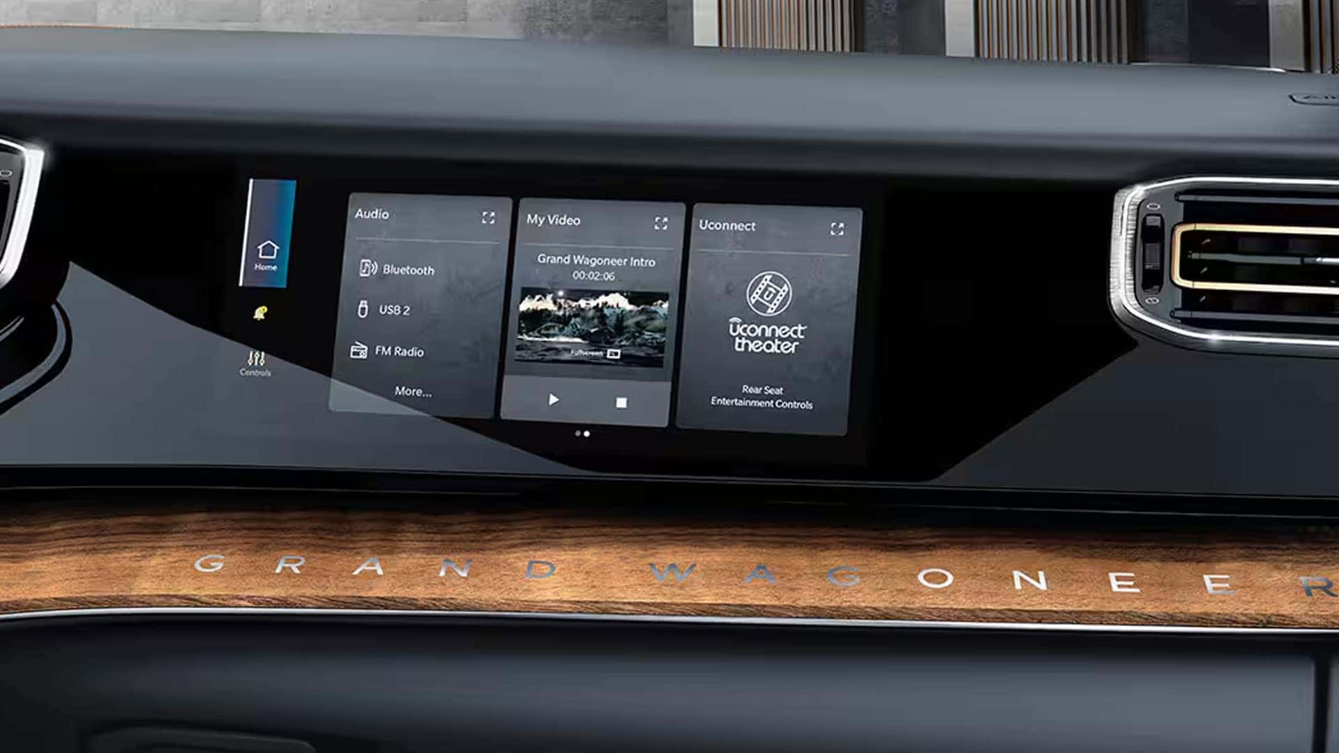 2026 Jeep Grand Wagoneer passenger-side dashboard screen showing audio, video and Uconnect controls above wood trim.