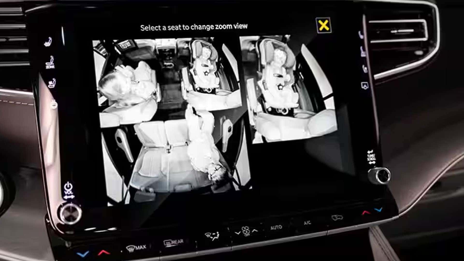 2026 Jeep Grand Wagoneer center touchscreen showing split black-and-white interior camera views of rear seats.