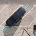 2026 Jeep Grand Wagoneer shown from above angled in a parking space with blue sensor graphics around the vehicle.