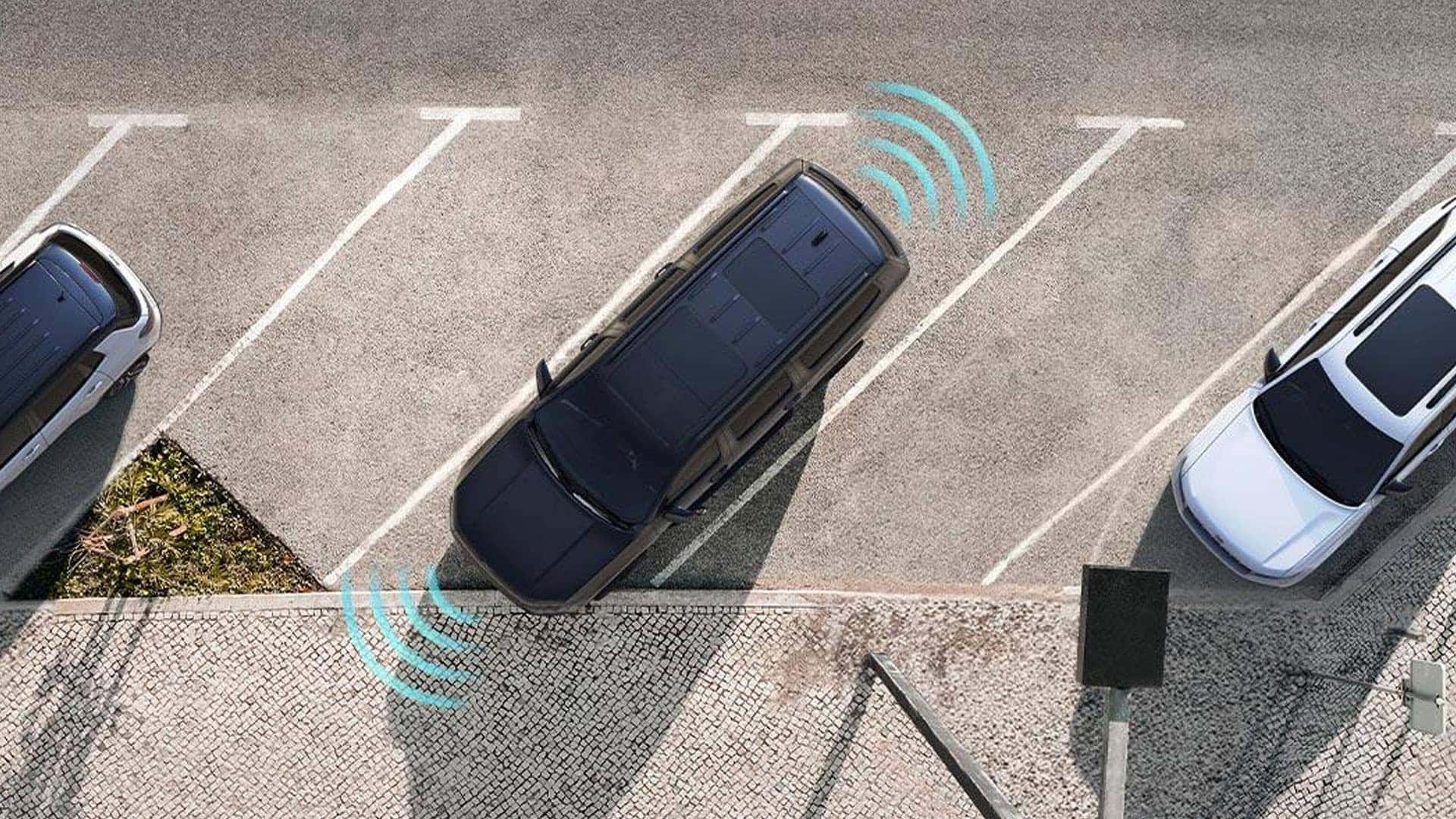 2026 Jeep Grand Wagoneer shown from above angled in a parking space with blue sensor graphics around the vehicle.