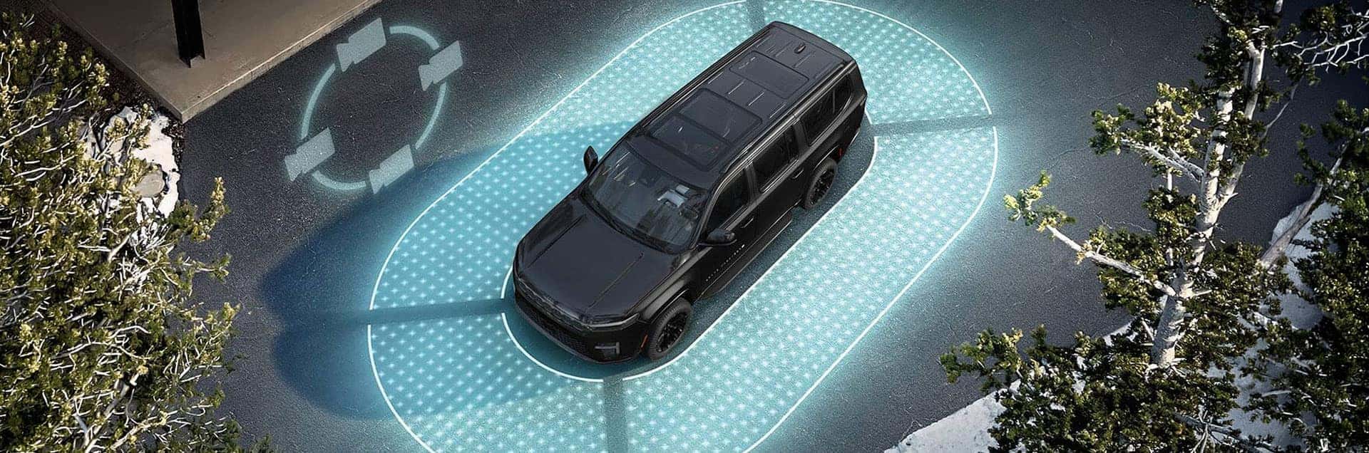 2026 Jeep Grand Wagoneer shown from above on a road with blue illuminated sensor coverage surrounding the vehicle.