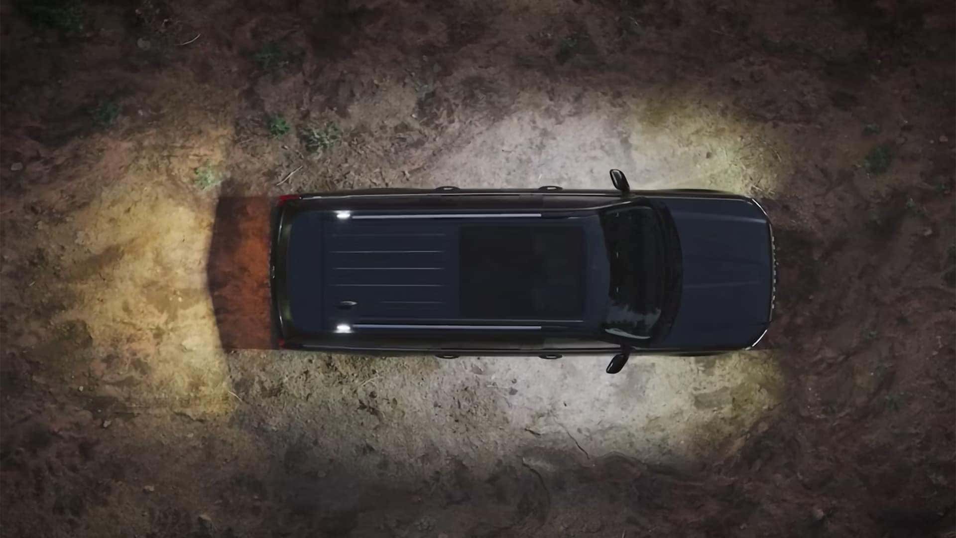Overhead view of a 2026 Ford Expedition using exterior Zone Lighting on a dark trail