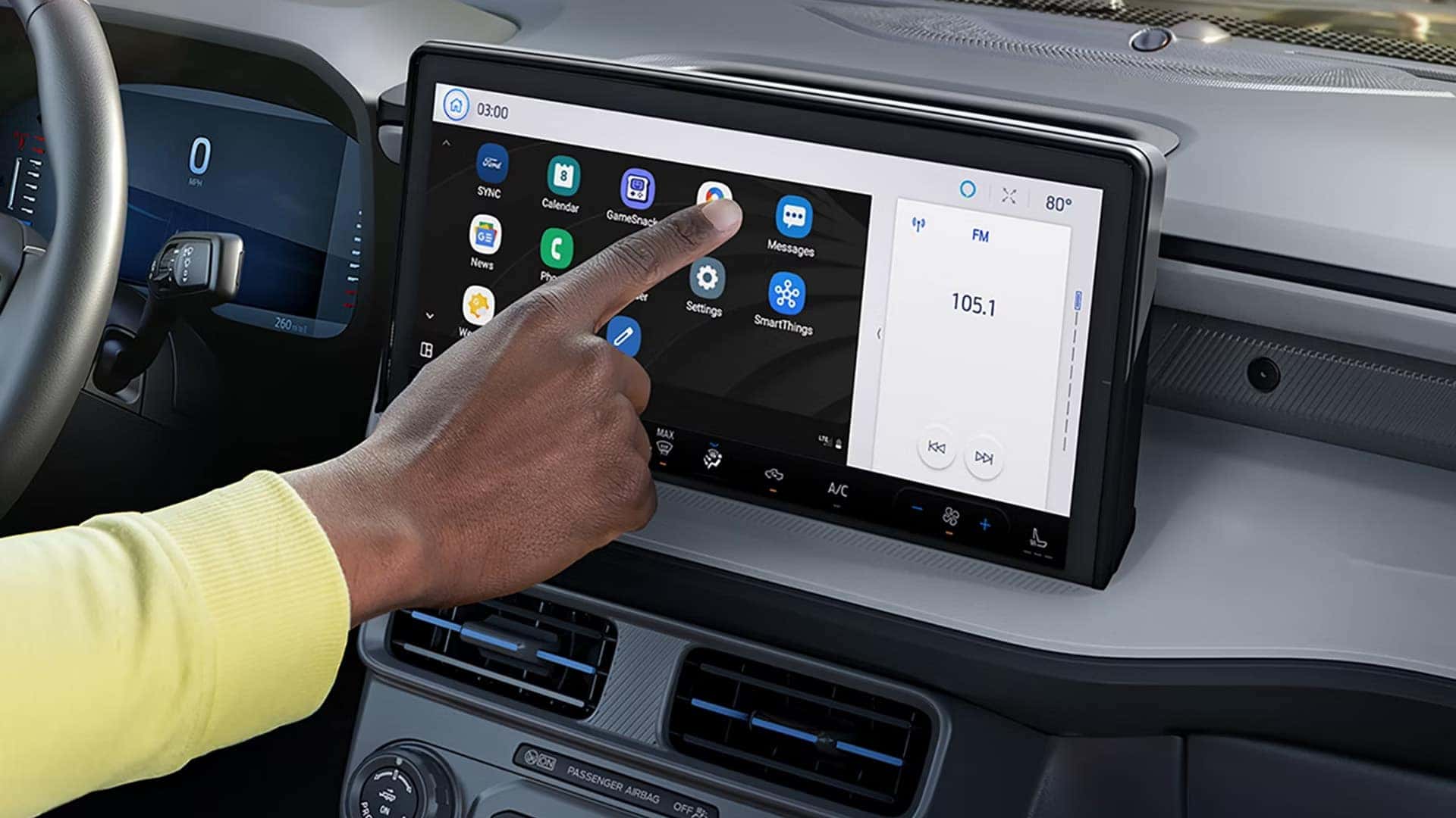Driver using the center touchscreen in a 2026 Ford Maverick