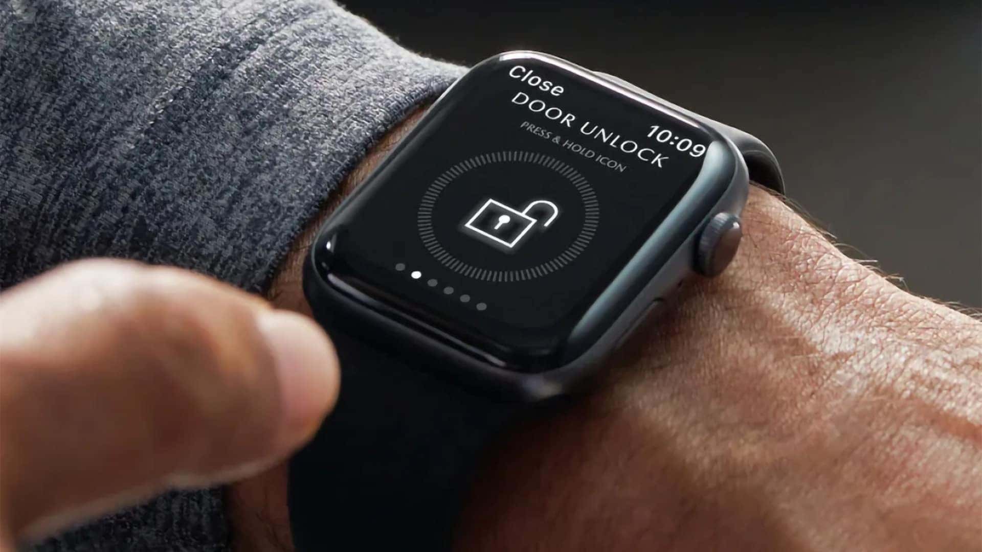 Smartwatch displaying a remote door unlock command for Mazda connected vehicle services