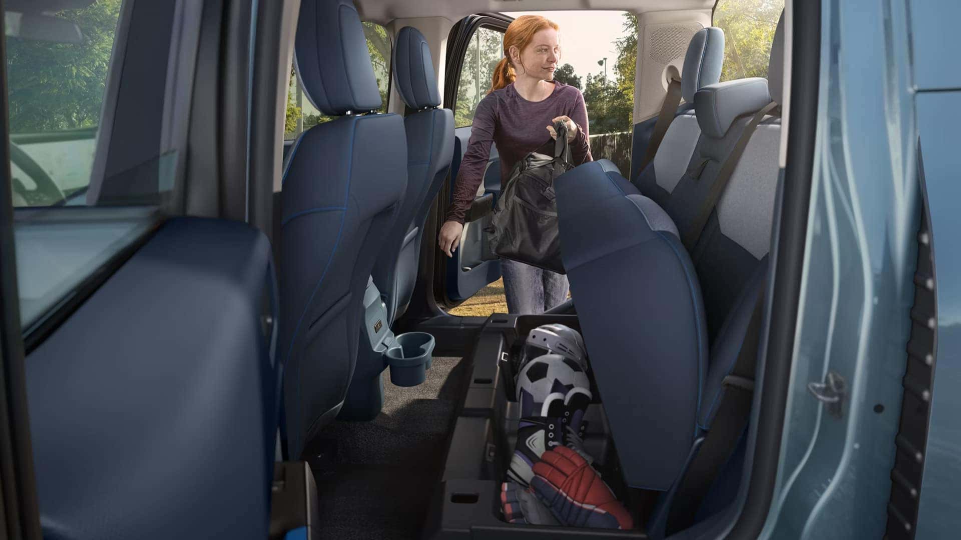 Rear seat lifted to reveal under-seat storage in a 2026 Ford Maverick