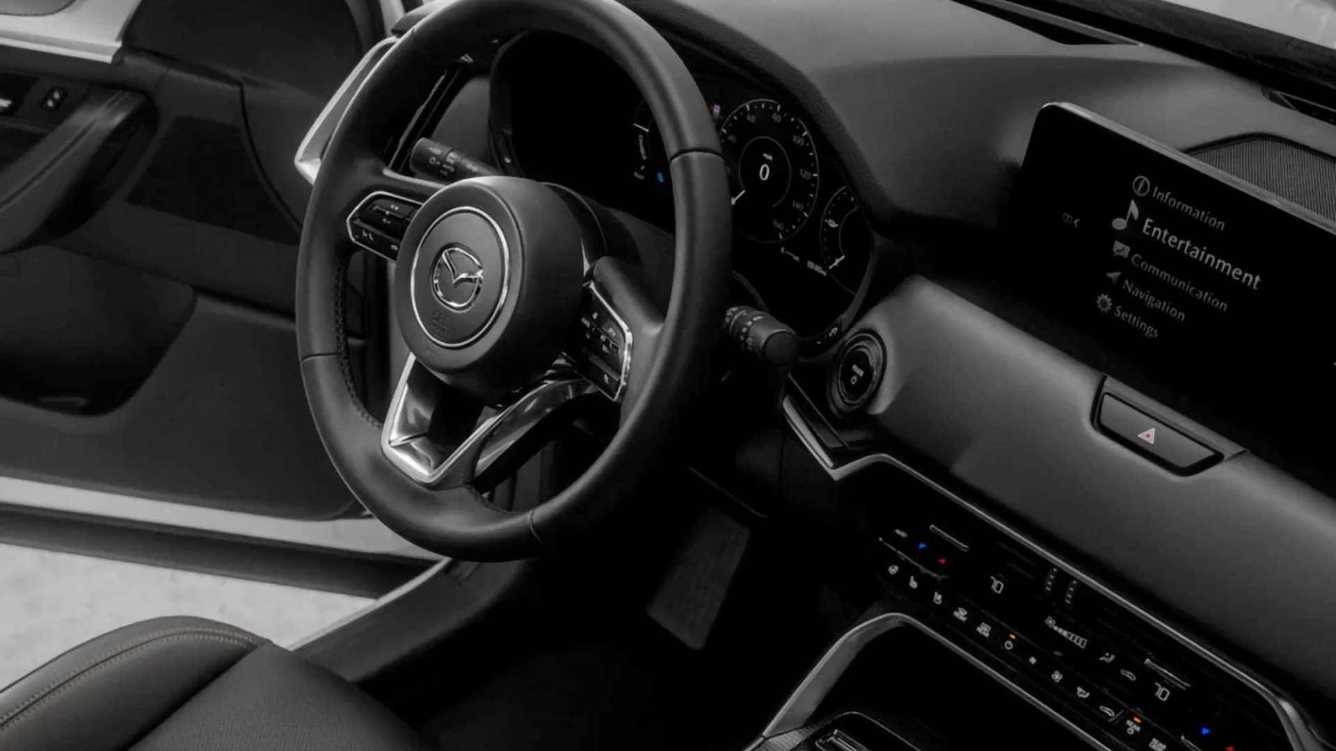 2026 Mazda CX-70 PHEV steering wheel, digital gauge display, and center infotainment screen