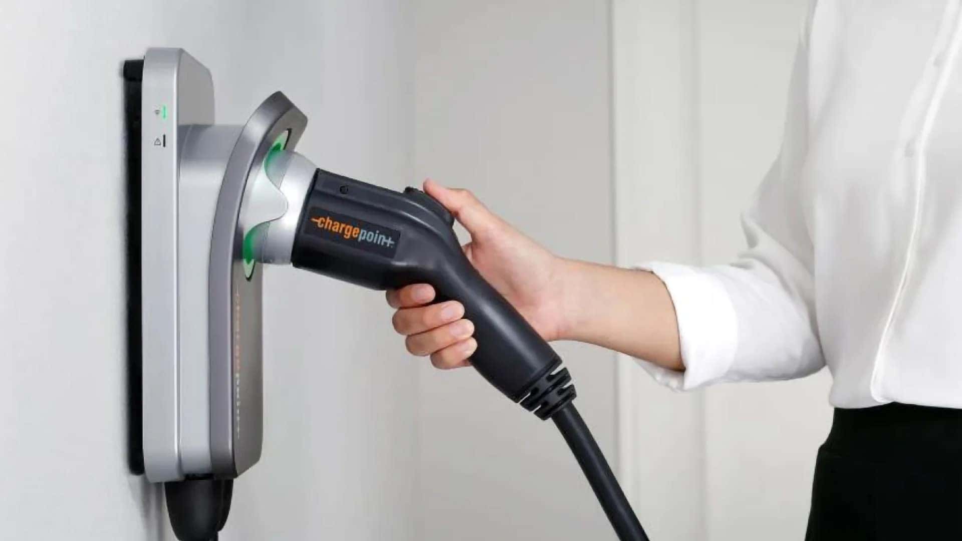 Driver removing a Level 2 charging connector for the 2026 Mazda CX-70 PHEV