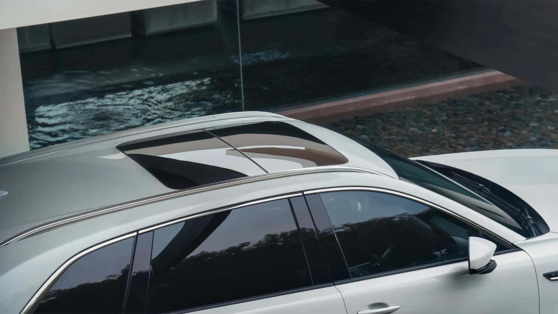 Open panoramic moonroof on a white 2026 Mazda CX-90 PHEV viewed from above