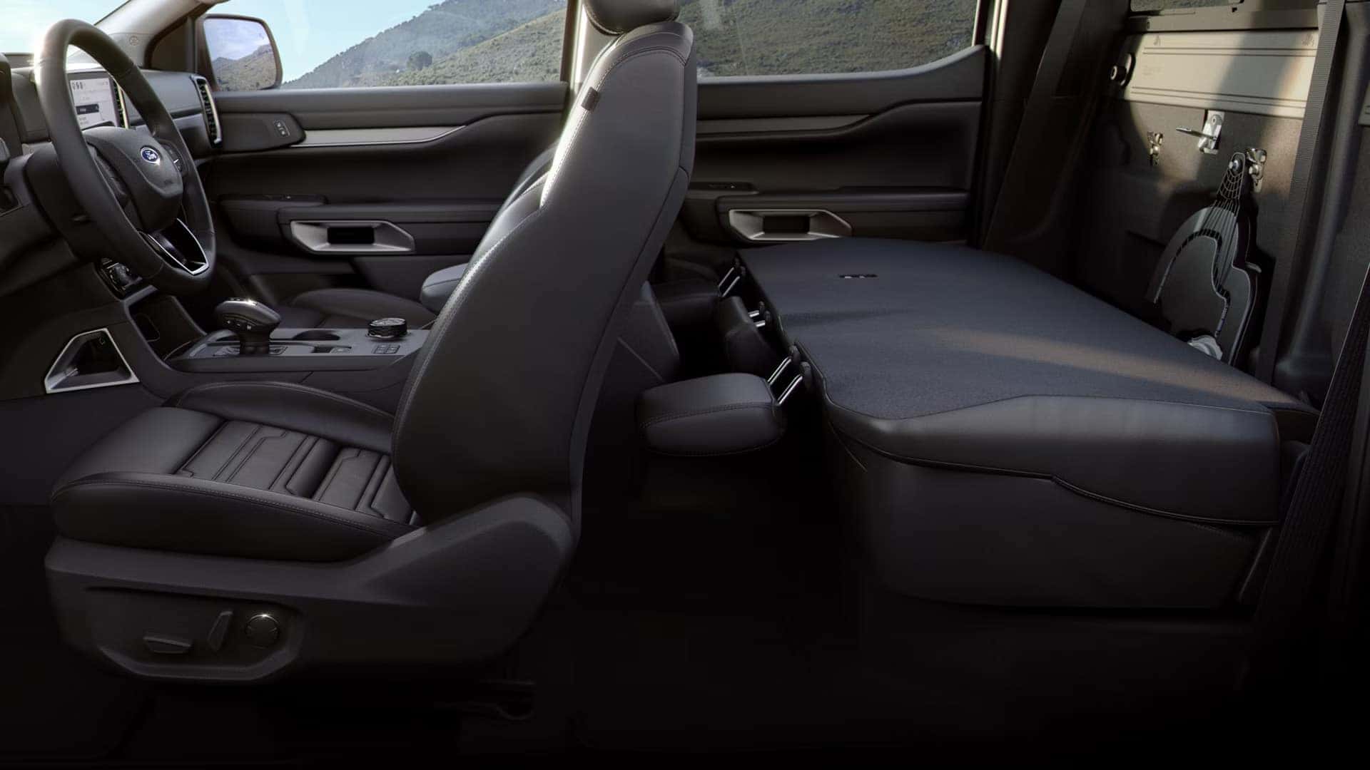 2026 Ford Ranger interior with rear bench folded flat for additional in-cabin storage space