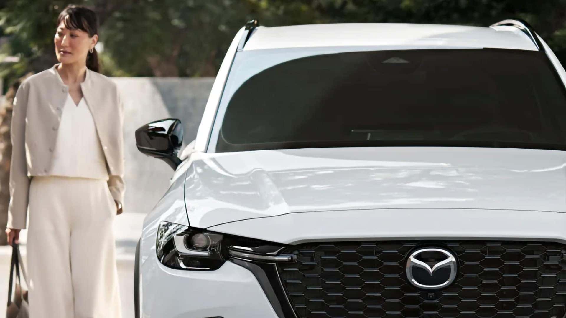 Front view of a white 2026 Mazda CX-70 PHEV with black grille and LED headlight