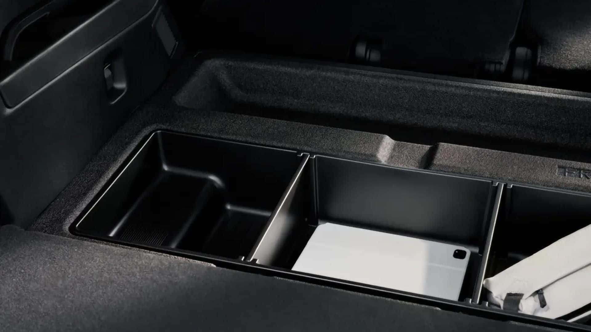 Underfloor cargo storage compartment in the 2026 Mazda CX-70 PHEV holding a tablet and small items