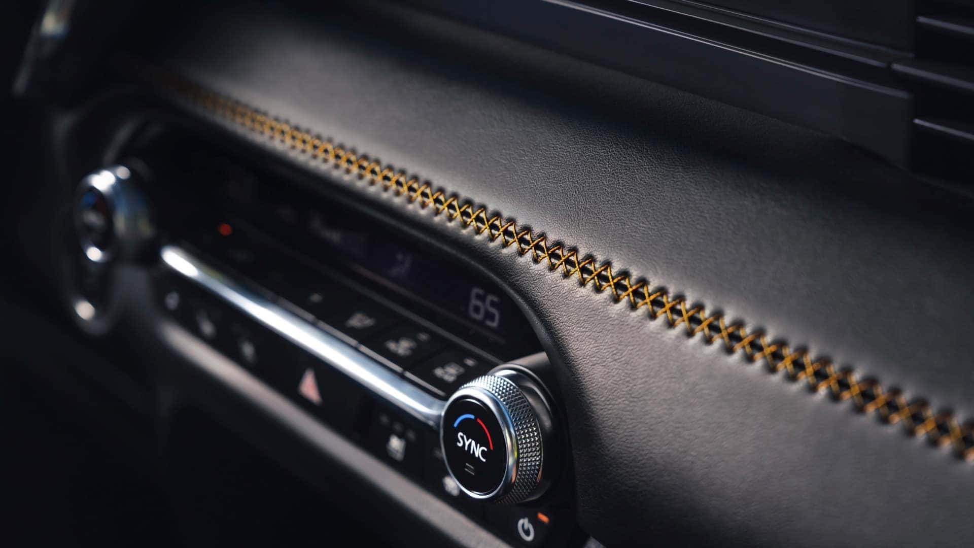 2026 Mazda CX-50 Hybrid dashboard with contrast stitching and dual-zone climate controls