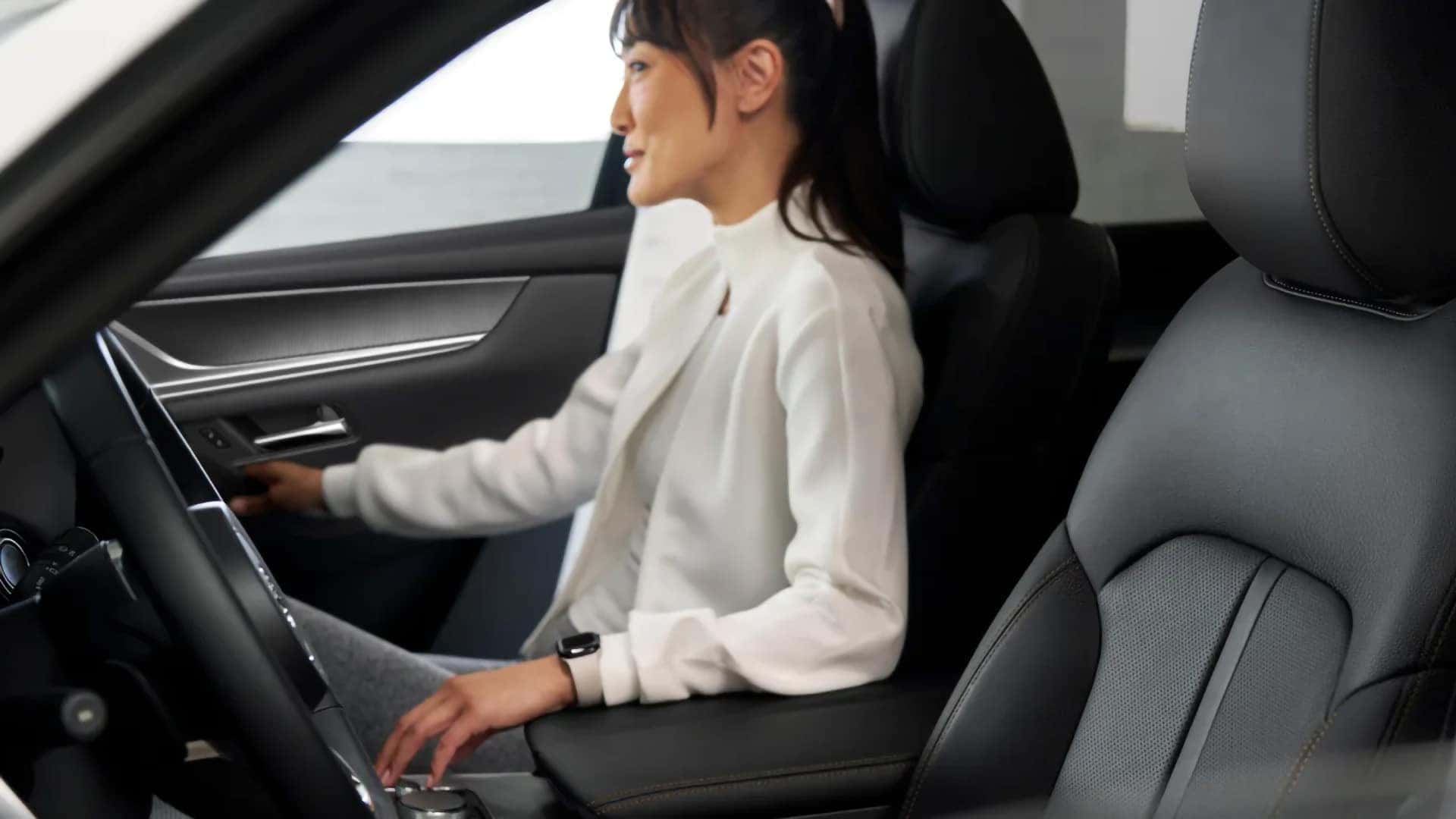 Driver seated in the black leather interior of the 2026 Mazda CX-70 PHEV