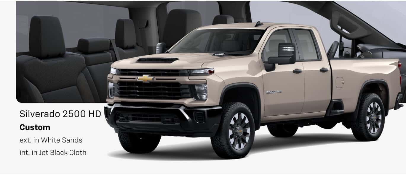 Front three-quarter view of a 2026 Chevrolet Silverado 2500 HD Custom in White Sands with Jet Black Cloth interior.